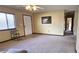 Cozy living room with neutral carpet, lots of natural light, and an adjacent hallway at 8516 Sw 105Th Pl, Ocala, FL 34481