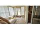 Enclosed sunroom area with a couch, perfect for relaxation and enjoying natural light and a view at 8516 Sw 105Th Pl, Ocala, FL 34481