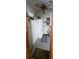Utility room with water heater, storage cabinets, and a white refrigerator at 8516 Sw 105Th Pl, Ocala, FL 34481