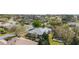 An aerial view shows a home with a landscaped yard in a neighborhood with mature trees at 8961 Se 130Th Loop, Summerfield, FL 34491