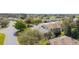 An aerial view shows a home with a landscaped yard in a neighborhood with mature trees at 8961 Se 130Th Loop, Summerfield, FL 34491