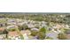 An aerial view shows a residential neighborhood with mature trees and well-maintained homes at 8961 Se 130Th Loop, Summerfield, FL 34491