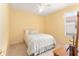 Small bedroom with yellow walls and a twin bed. The room is well lit at 8961 Se 130Th Loop, Summerfield, FL 34491