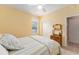 This bedroom has yellow walls and a twin bed, and is adjacent to the bathroom at 8961 Se 130Th Loop, Summerfield, FL 34491