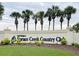 Del Webb's Spruce Creek Country Club entrance sign with well manicured lawn and palm trees at 8961 Se 130Th Loop, Summerfield, FL 34491