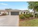 Charming home featuring a two-car garage, meticulous landscaping, and a well-maintained lawn at 8961 Se 130Th Loop, Summerfield, FL 34491