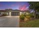 Charming home featuring a two-car garage, meticulous landscaping, and a well-maintained lawn at 8961 Se 130Th Loop, Summerfield, FL 34491
