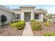 Inviting entryway showcasing a well-maintained walkway, lush landscaping, and a charming front door at 8961 Se 130Th Loop, Summerfield, FL 34491