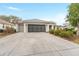 Charming single-story home with a wide driveway and well-manicured landscaping at 8961 Se 130Th Loop, Summerfield, FL 34491
