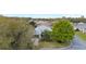 An aerial view shows a home with a well-maintained lawn and mature trees at 8961 Se 130Th Loop, Summerfield, FL 34491
