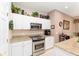 Updated kitchen shows white cabinets, granite countertops, stainless steel appliances, and ample storage at 8961 Se 130Th Loop, Summerfield, FL 34491