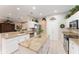 Modern kitchen with white cabinetry, granite countertops, stainless steel appliances, and tile floors at 8961 Se 130Th Loop, Summerfield, FL 34491