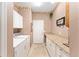 Bright laundry room with granite countertops, tile flooring, and newer washer/dryer at 8961 Se 130Th Loop, Summerfield, FL 34491