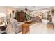 Cozy living room featuring tile flooring, comfortable seating, and stylish decor at 8961 Se 130Th Loop, Summerfield, FL 34491