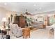Cozy living room features tile floors, ceiling fan, comfortable seating, and display cabinets at 8961 Se 130Th Loop, Summerfield, FL 34491