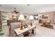 Open living space with tile floors seamlessly connects the kitchen, dining area, and entryway at 8961 Se 130Th Loop, Summerfield, FL 34491