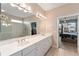 Bright main bathroom showing an extra-large vanity with double sinks, and the shower room at 8961 Se 130Th Loop, Summerfield, FL 34491