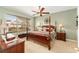 The main bedroom is well lit, with a ceiling fan, and has a view of the neighborhood outside the window at 8961 Se 130Th Loop, Summerfield, FL 34491