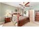 The main bedroom features a four-poster bed, side tables with lamps, and pale-green painted walls at 8961 Se 130Th Loop, Summerfield, FL 34491