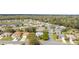 Community aerial showcasing the neighborhood's layout, pond, and surrounding nature at 8961 Se 130Th Loop, Summerfield, FL 34491