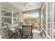 A cozy patio with a ceiling fan, outdoor furniture, and screened windows at 8961 Se 130Th Loop, Summerfield, FL 34491