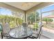 Covered patio with table and chairs offering private outdoor space at 8961 Se 130Th Loop, Summerfield, FL 34491