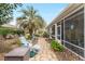 Inviting backyard space with a screened lanai, stone pathway, and serene seating area at 8961 Se 130Th Loop, Summerfield, FL 34491