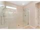 Bright main bathroom with a large shower with clear glass and double shower heads at 8961 Se 130Th Loop, Summerfield, FL 34491