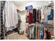 A fully-outfitted walk-in closet with shelving and racks for organizing clothes and accessories at 8961 Se 130Th Loop, Summerfield, FL 34491