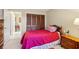 Bedroom features a twin bed, wooden furnishings, and carpet at 9305 Bahia Track Way, Ocala, FL 34472
