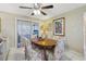 Charming dining room with floral upholstered chairs and sliding glass doors for natural light at 9305 Bahia Track Way, Ocala, FL 34472