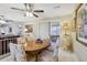 Bright dining area with a wooden table, upholstered chairs, and easy access to the living room at 9305 Bahia Track Way, Ocala, FL 34472