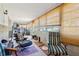 The bright Florida room has many windows with shades, tile floor, and is furnished as a secondary living space at 9305 Bahia Track Way, Ocala, FL 34472