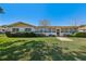 Charming single story home with a well-manicured lawn, mature landscaping, and a sidewalk leading to the front door at 9305 Bahia Track Way, Ocala, FL 34472
