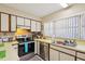 Efficient kitchen with stainless steel appliances, bright countertops and a convenient stainless sink at 9305 Bahia Track Way, Ocala, FL 34472