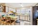 Well-lit kitchen with stainless steel appliances, bright countertops and an adjacent breakfast bar at 9305 Bahia Track Way, Ocala, FL 34472