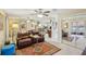 Inviting living room featuring comfortable seating, ceiling fan, and seamless flow into other living spaces at 9305 Bahia Track Way, Ocala, FL 34472