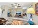 Bright living room featuring mirrored closet doors, modern decor, and access to an outdoor space at 9305 Bahia Track Way, Ocala, FL 34472