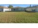 Spacious backyard featuring green grass and exterior view of the home; great potential for outdoor activities at 9463 Sw 93Rd Loop, Ocala, FL 34481