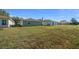 Spacious backyard with well-maintained grass that is surrounded by charming neighboring homes at 9463 Sw 93Rd Loop, Ocala, FL 34481