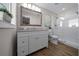 Bathroom featuring a glass shower, a large mirror, and a white vanity at 9463 Sw 93Rd Loop, Ocala, FL 34481