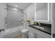 Elegant bathroom features a shower-tub combo, designer tile and a modern vanity at 9463 Sw 93Rd Loop, Ocala, FL 34481