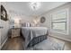 Cozy bedroom featuring an accent wall, natural light, and wood-look floors at 9463 Sw 93Rd Loop, Ocala, FL 34481