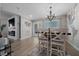 Dining room with a rustic chandelier, accent wall map, and decorative fireplace at 9463 Sw 93Rd Loop, Ocala, FL 34481