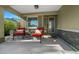 Welcoming front porch with cozy chairs, decorative pillows, and a stylish glass-paneled front door at 9463 Sw 93Rd Loop, Ocala, FL 34481