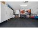Organized garage equipped with cabinets, shelving and storage space with epoxy flooring at 9463 Sw 93Rd Loop, Ocala, FL 34481