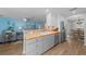 Modern kitchen with updated stainless steel appliances, and an open view to the living area at 9463 Sw 93Rd Loop, Ocala, FL 34481