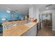 Bright kitchen featuring wood counters, stainless steel appliances, and a decorative backsplash at 9463 Sw 93Rd Loop, Ocala, FL 34481