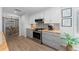 Well-lit kitchen with white cabinets, stainless steel appliances, and colorful backsplash at 9463 Sw 93Rd Loop, Ocala, FL 34481