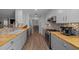 Well-equipped kitchen featuring modern appliances, butcher block countertops, and stylish tile backsplash at 9463 Sw 93Rd Loop, Ocala, FL 34481